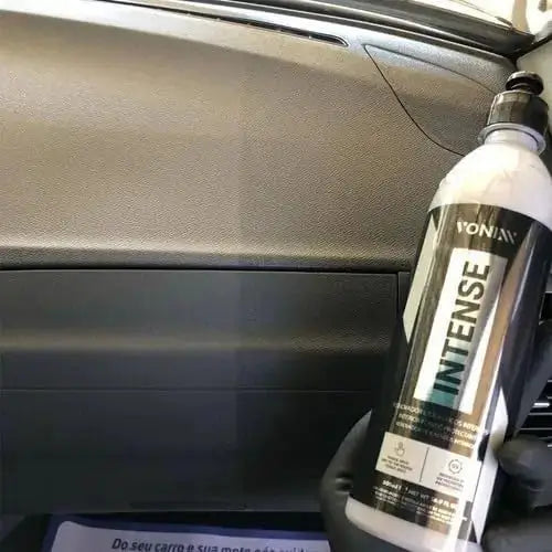 INTENSE plastic restorer from Full Car Wash Kit Vonixx applied to dashboard, showing contrast between treated and untreated surfaces.